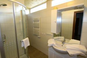 a bathroom with a sink and a shower and a mirror at Villa Grossglockner Heiligenblut in Heiligenblut +62 photos