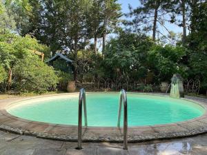 a small swimming pool with two metal bars around it at Cottage chaleureux avec piscine privée in Sainte Anastasie - Aubarne
