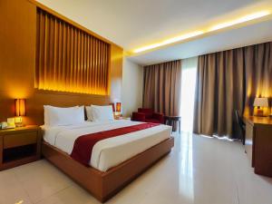 a hotel room with a bed and a large window at Seminyak Square Hotel And Villas in Seminyak