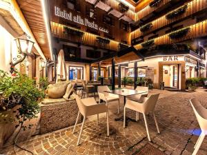 a restaurant with a table and chairs in a building at Hotel Alla Posta in Alleghe