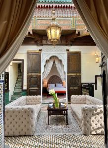 a living room with two couches and a fireplace at Palais De Fès Suites & Spa in Fez