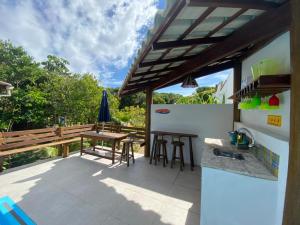 an outdoor kitchen with a table and a counter at Casa Boomerang in Marau