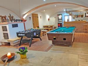 a living room with a pool table and ping pong at Ferienwohnungen Anni im Paradies in Kiefersfelden