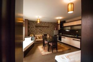 a kitchen and living room with a table and a couch at SPA Apartments Perun in Sandanski