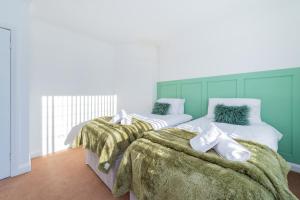 赫斯華爾的住宿－Premium 4 Bed Detached in Heswall，两张睡床彼此相邻,位于一个房间里