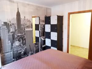 a room with a wall with a picture of a city at Apartment Carmen in Nachdemsee