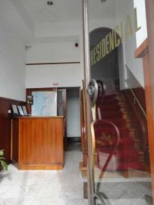 a lobby with a staircase and a desk in a building at Internacional in Coimbra