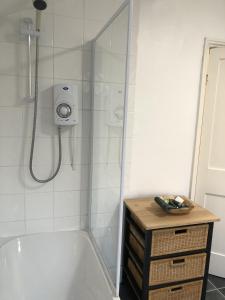 a bathroom with a shower and a bath tub with a sink at River Terrace in Lancaster