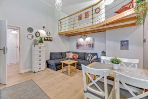 a living room with a couch and a table at K2018 Mezzo Grand Tourist Apartments in Gdańsk