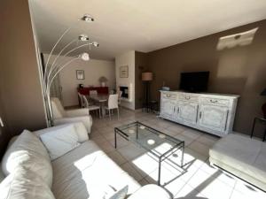 una sala de estar con un sofá y una mesa en Maison la Soleiade, en Carcassonne