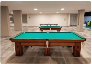 two pool tables in an empty room with a pool table at PARK VEREDAS Flat 707 in Rio Quente