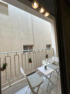a balcony with two chairs and a table on a building at 3 Bedroom Apartment in Riyadh