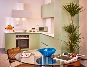 a kitchen with a table with a blue bowl on it at Right House - Indipendent in Characteristic Marina District in Cagliari