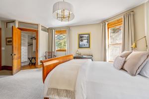 a bedroom with a white bed and a window at Stratton Creek Inn 