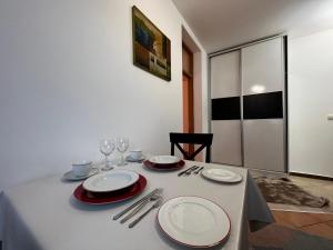 a table with plates and wine glasses on it at Sunrise Apartment in Prishtina, Kosovo in Pristina +14 photos