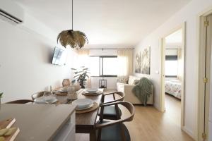 a kitchen and living room with a table and chairs at FLORIT FLATS - The Apolo Apartment in Valencia