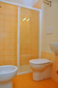 W łazience znajduje się prysznic, toaleta i umywalka. w obiekcie Condominio Biloba w Bibione