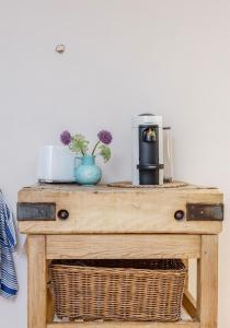 una mesa de madera con una cafetera encima en Notting Hill London - Chic Bright Apartment W11, en Londres