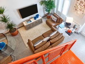 an overhead view of a living room with furniture and a flat screen tv at Right House - Indipendent in Characteristic Marina District in Cagliari