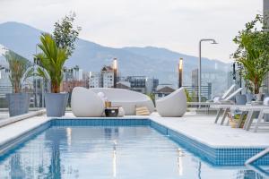 a swimming pool on top of a building at Landmark Hotel in Medellín