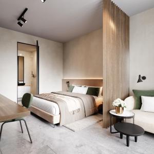 瓦勒海姆的住宿－Hotel T，一间卧室配有一张床和一张沙发