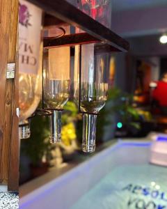 un grupo de copas de vino colgando en un mostrador en ABS Pool Condo, en Nanwan