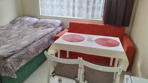 a small room with a table and a bed at Burgas Central-Sheynovo in Burgas City +11 photos