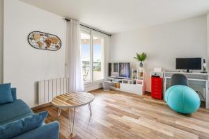 a living room with a blue couch and a table at Charming 1br with terrace close to Paris - Asnières - Welkeys in Asnières-sur-Seine