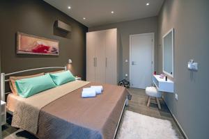 a bedroom with a bed with two towels on it at Calma Apartment in Rhodes Town