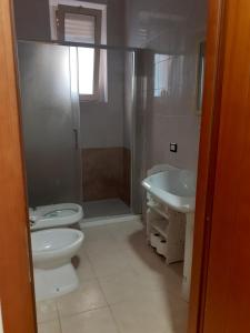 a bathroom with a toilet and a sink and a shower at Sweet Home Tempo Libero in San Severo +21 photos