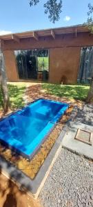 a swimming pool in the yard of a house at Hartbees Bush Lodge 1 in Hartbeespoort +17 photos