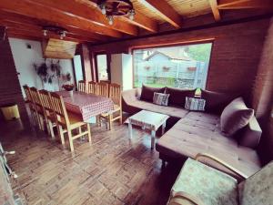 a living room with a couch and a table at Casa de vacanta Estera Rucar in Rucăr
