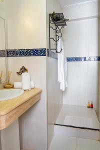 W łazience znajduje się umywalka i lustro. w obiekcie Riad Le Marocain w Marakeszu
