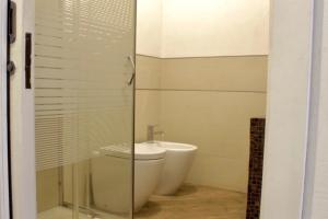 a bathroom with a sink and a toilet and a shower at La tua Kimera in Rozzano +12 photos
