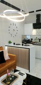 a kitchen with a couch and a table in a room at VIP Room 2+2 in Konin