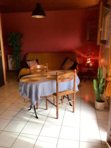 a table and chairs in a living room at Maison d'une chambre avec jardin et wifi a Lectoure a 4 km de la plage in Lectoure