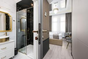 a bathroom with a shower and a sink at Salomea krakow apartments Bożego Ciała in Kraków +112 photos