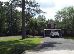 a house with a truck parked in front of it at Pure Country, plenty of space & trees, relaxing! in Lumberton