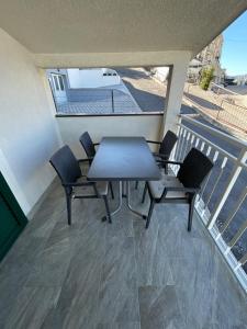 a patio with a table and chairs on a balcony at Apartments Holiday Gavric in Trogir