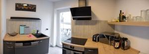 a kitchen with a counter and a stove top oven at Garden Town Appartement in Salzburg