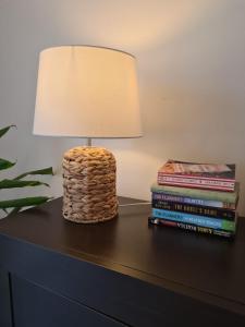 a lamp sitting on top of a table with books at St Anthony's House with Parking in Zagreb