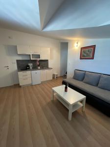 a living room with a couch and a table at Apartments Holiday Gavric in Trogir