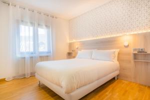 Łóżko lub łóżka w pokoju w obiekcie Hostal Gran Duque