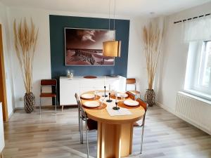 a dining room with a wooden table and chairs at Ferienwohnung Xxl Lausitz direkt in Radibor