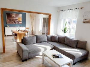 a living room with a couch and a table at Ferienwohnung Xxl Lausitz direkt in Radibor
