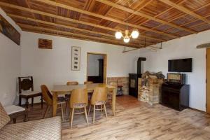 a living room with a wooden table and chairs at Šumavská Chata in Volary