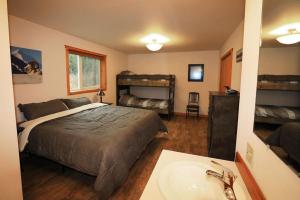 a bedroom with a bed and a bathroom with a sink at 3 Bedroom Home with Amazing Views 11 mi from Denali in Healy