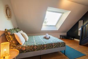 a room with a couch and a window at Loft les deux cèdres avec vue panoramique in Charleville-Mézières