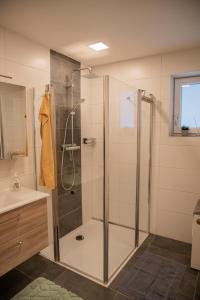 a bathroom with a shower and a sink at Ferienhaus Plöckenstein in Schwarzenberg am Bohmerwald