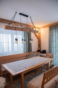 a dining room with a table and a couch at Ferienhaus Plöckenstein in Schwarzenberg am Bohmerwald